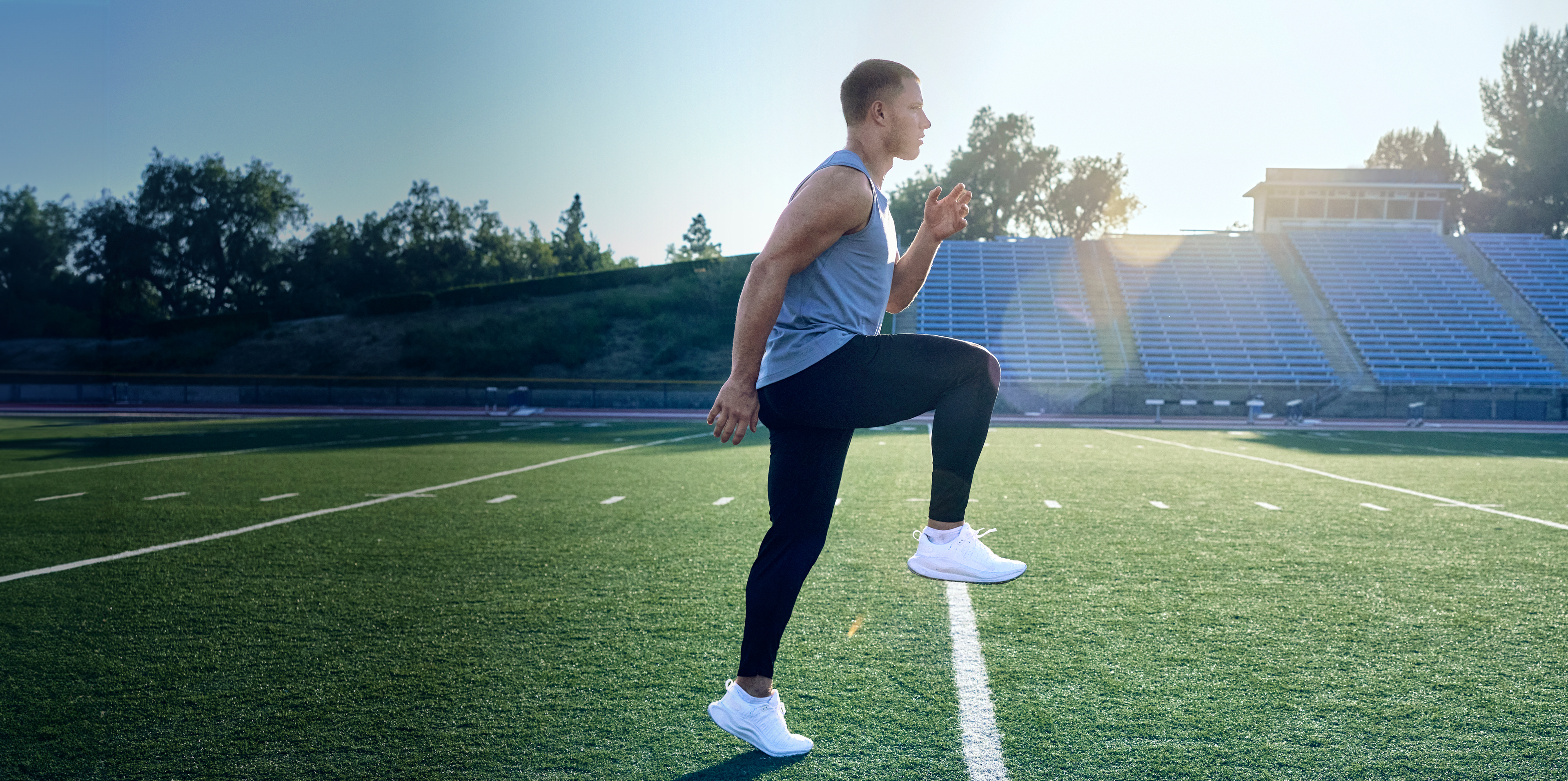 Christian McCaffrey stretching on the practice field